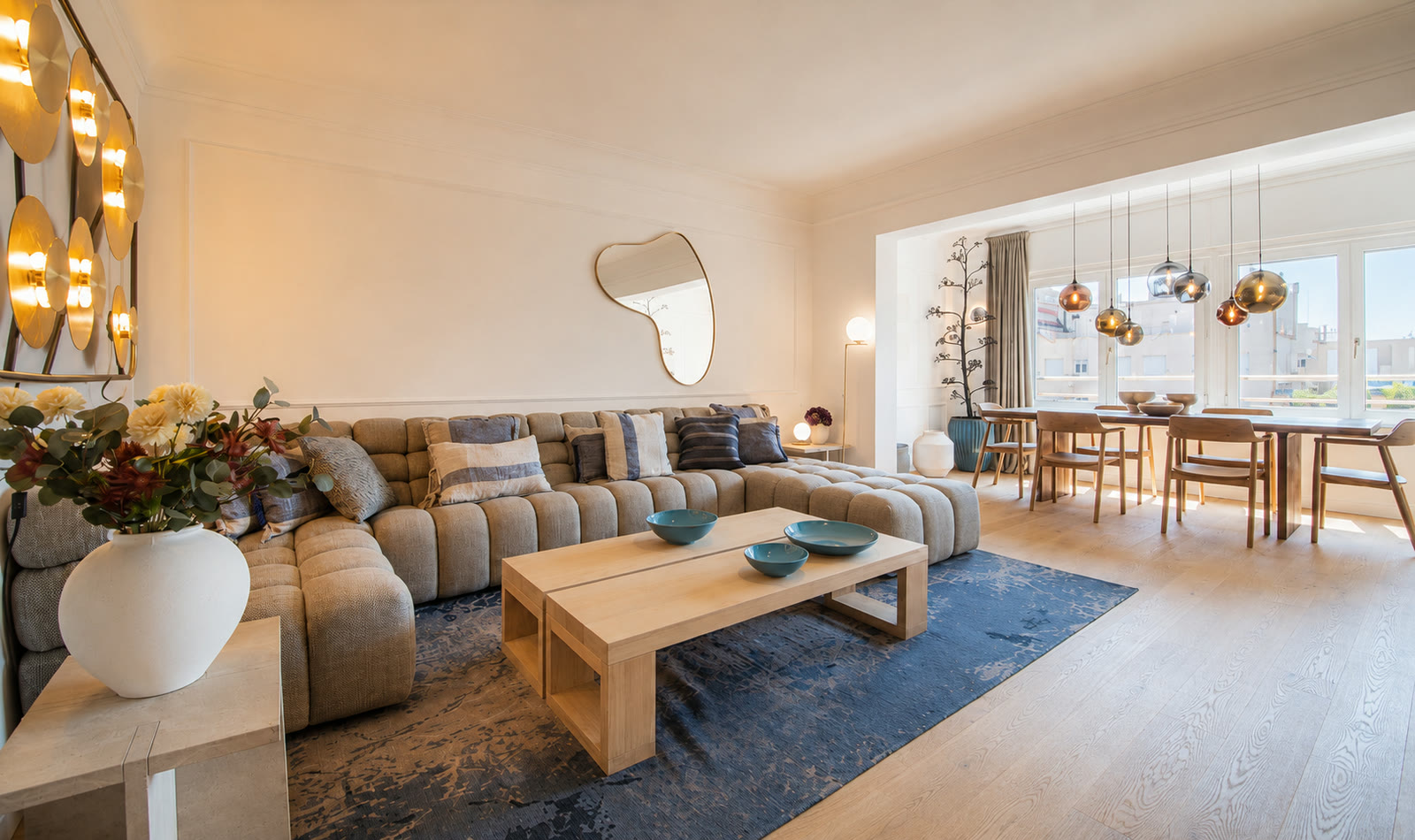 Elegant PDG15 apartment living and dining room with modular sofa, brass wall lights, and Passeig de Gracia views