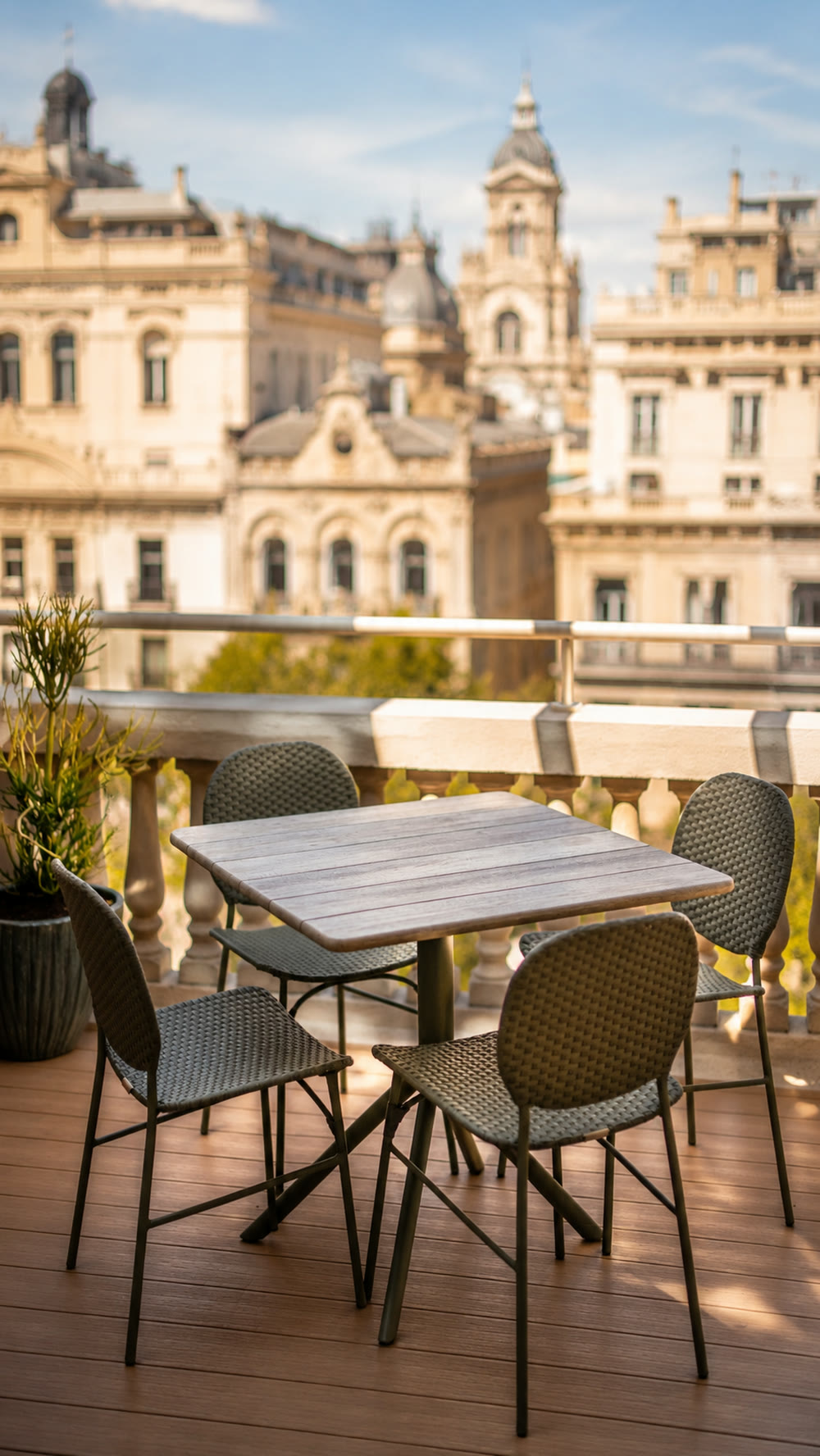 PDG15 private terrace with cafe table and chairs overlooking Passeig de Gracia rooftops