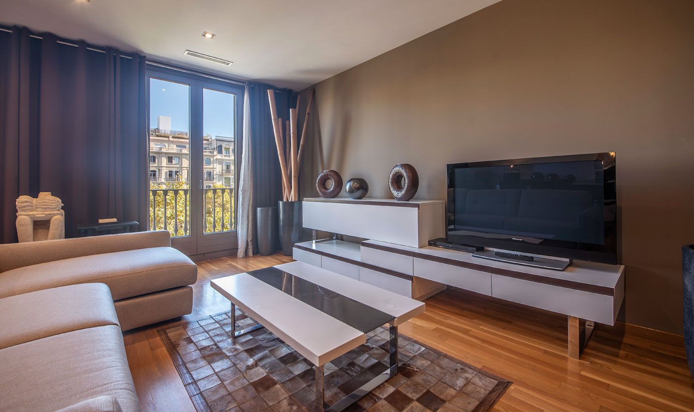 Living room television and balcony doors in Suite Sagrada