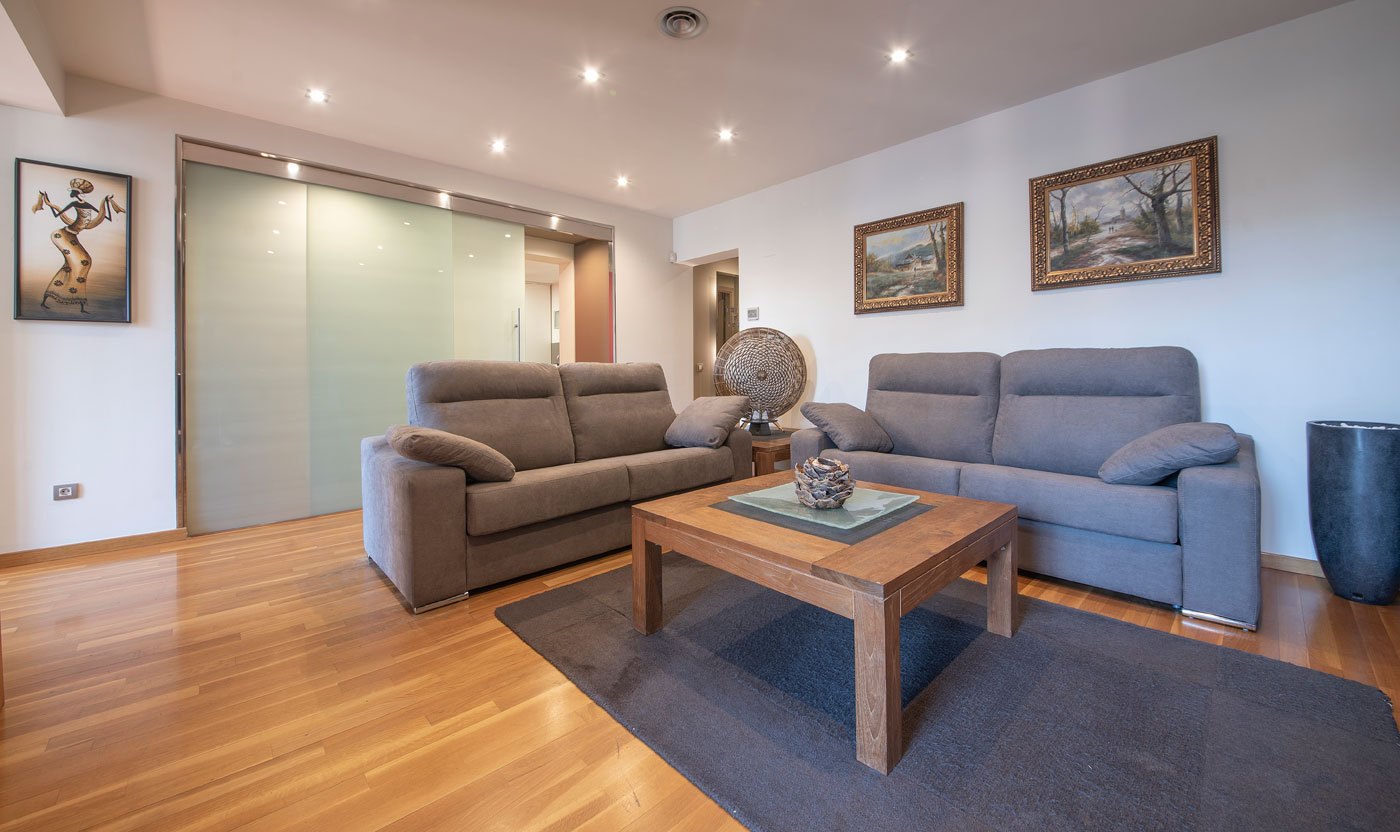Two grey sofas and a timber coffee table in Suite Sol&eacute;a
