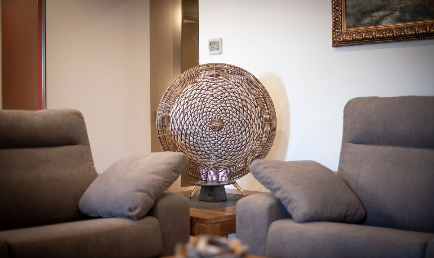 Woven artwork and armchair detail in the Suite Sol&eacute;a living room