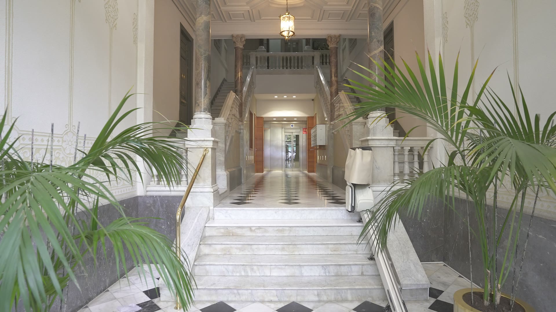 Marble entrance hall and ornate front door of the PDG15 building at Passeig de Gracia 15, Barcelona